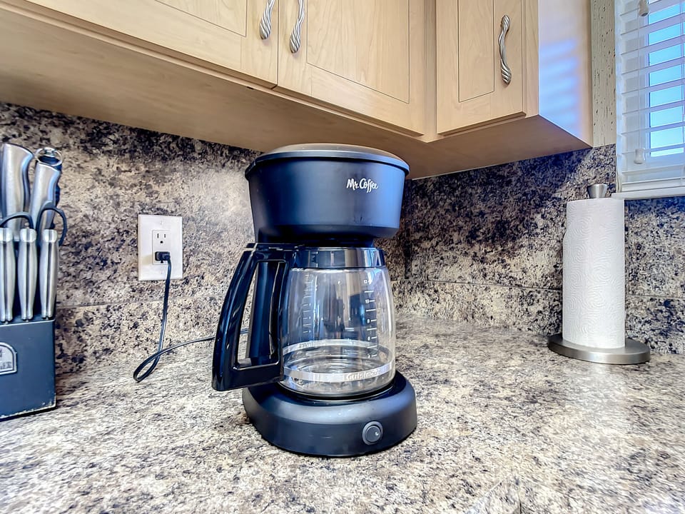 Start your mornings right with this convenient coffee maker, perfect for fresh brews to enjoy by the beach.
