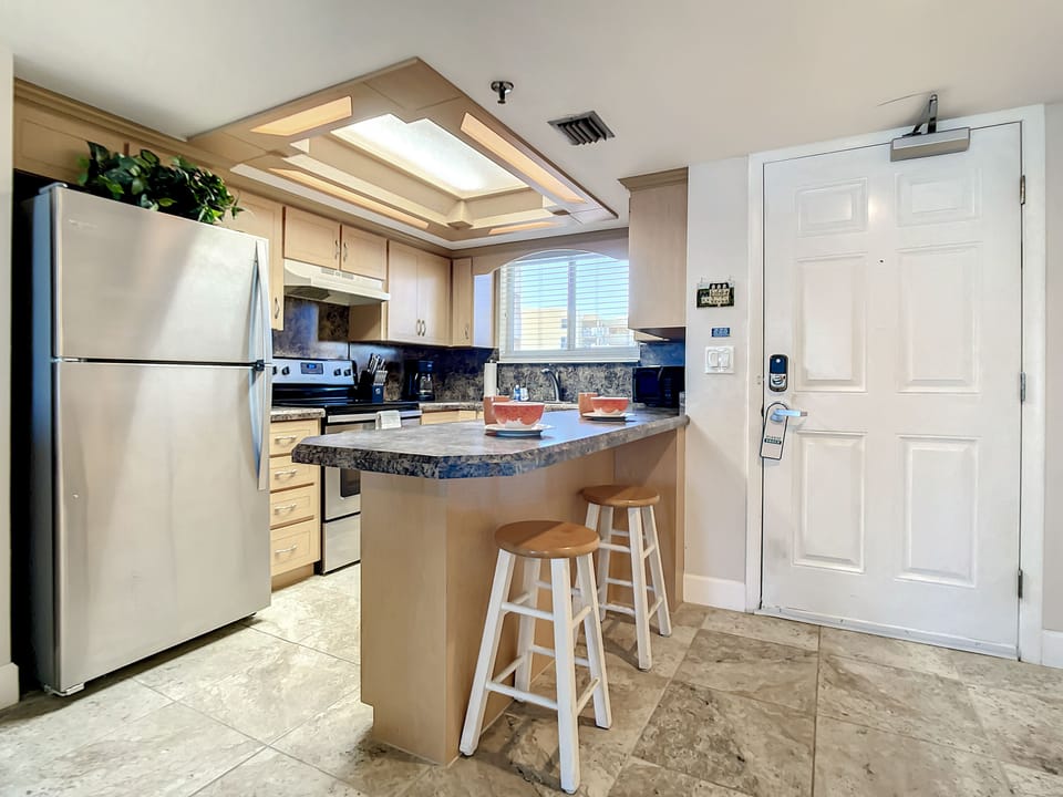 Enjoy a convenient breakfast bar in a fully equipped kitchen, perfect for quick meals or coffee breaks.