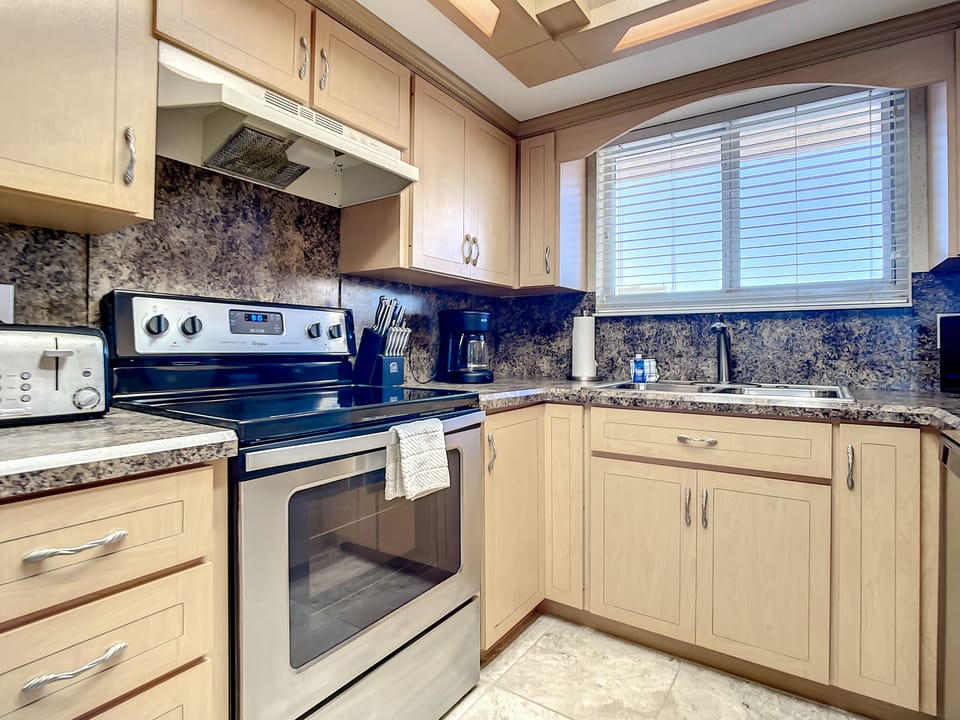 Fully equipped with stainless steel appliances and ample storage, this kitchen is ready for all your culinary needs.