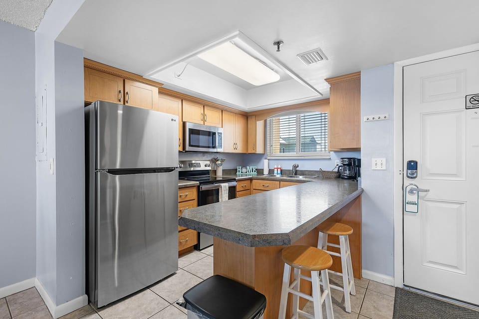 Enjoy a fully equipped kitchen perfect for your beach getaway. Featuring modern stainless-steel appliances, spacious counters, and a breakfast bar—ideal for quick bites before heading to the shore.