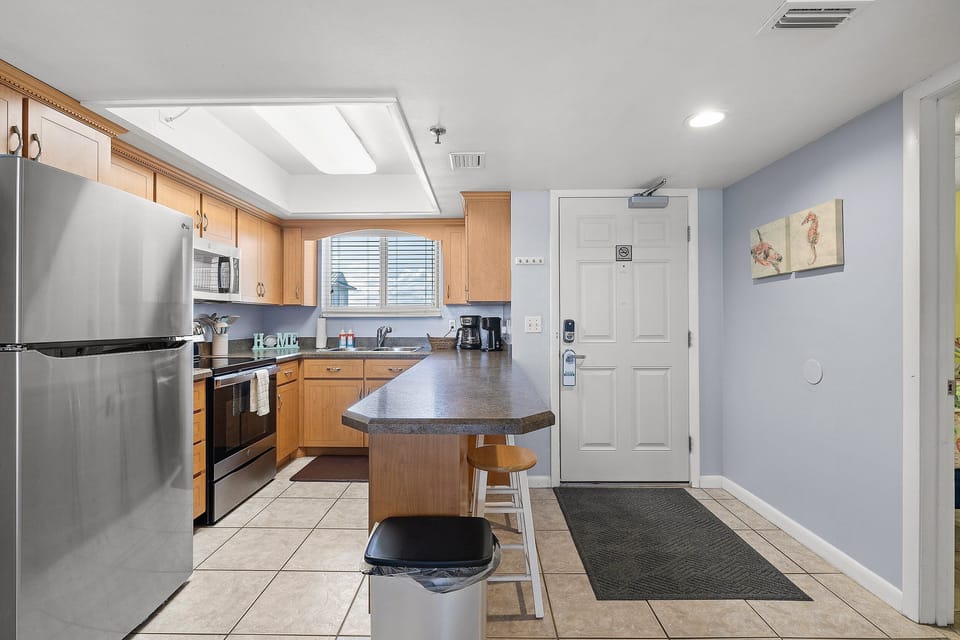 Cook beachside meals in this fully equipped kitchen featuring modern appliances, ample counter space, and coastal touches—perfect for fueling your oceanfront stay.