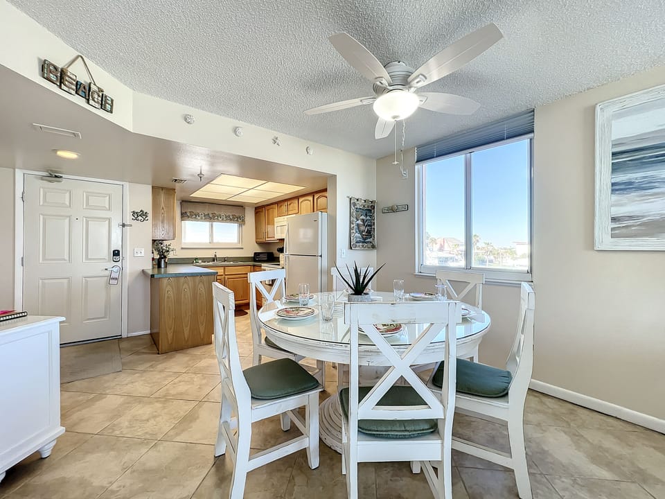 This open-concept dining area flows seamlessly into the living room, offering ocean views, natural light, and a relaxing coastal atmosphere for meals and gatherings.