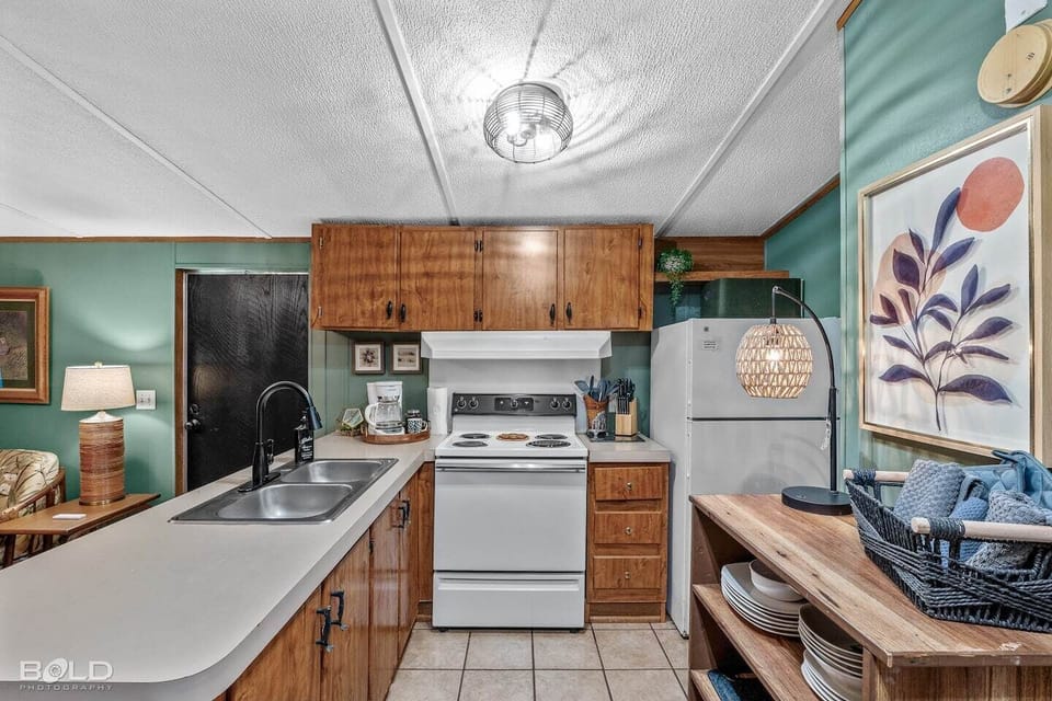 The full kitchen is stocked with dishes, pots & pans, coffee maker, etc...