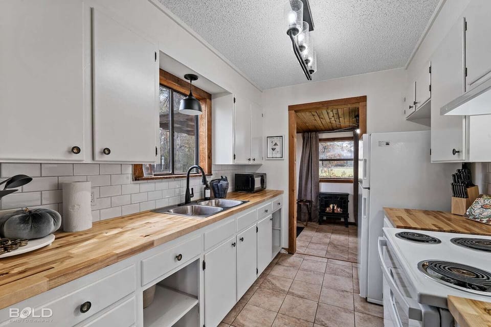 The full kitchen is stocked with dishes, pots, pans, utensils, etc!