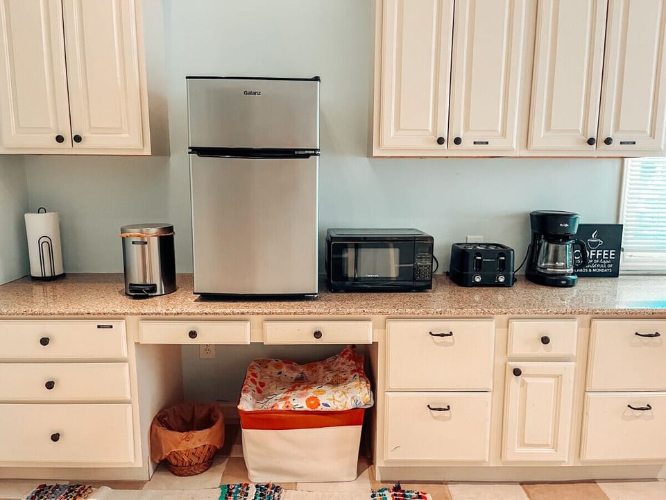 Kitchenette with drip coffee pot and grounds provided