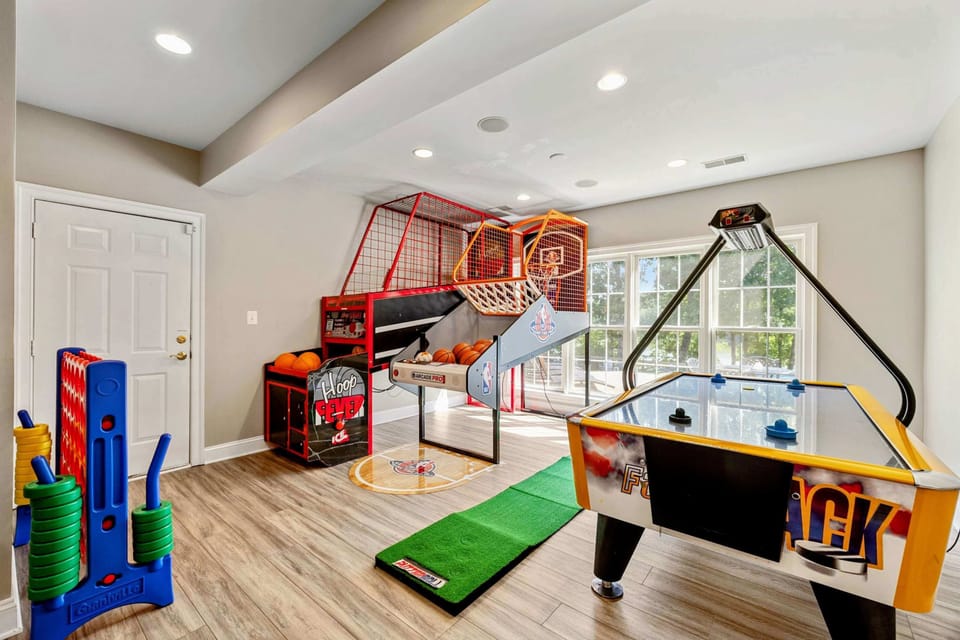 Game Room - Mini golf, basketball arcade, air hockey, and a pool table fill this space with competitive energy.