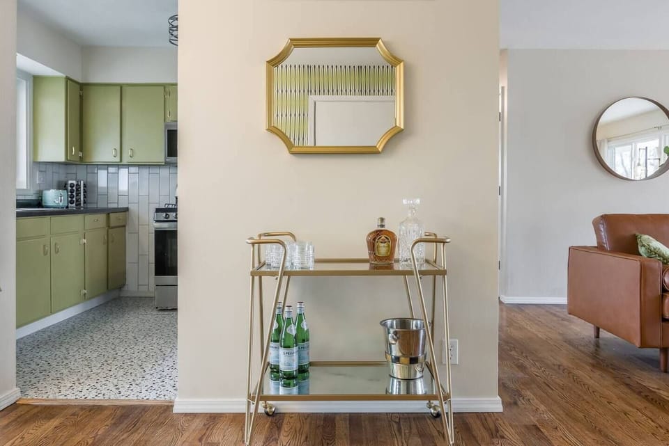 Pour a drink, settle in…this thoughtfully styled bar cart adds a touch of charm between the kitchen and living space.