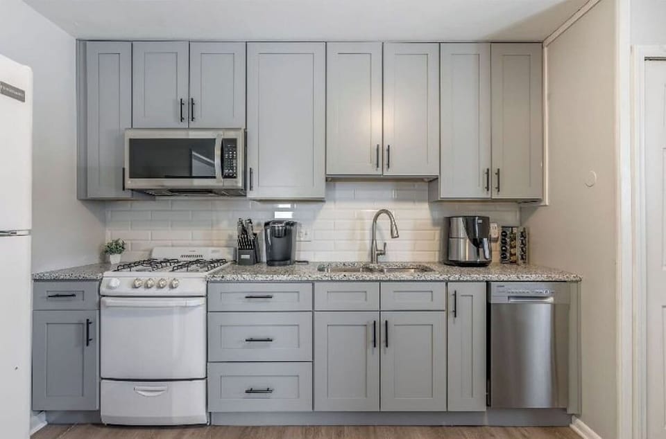Modern dining area with high-top table seating for four, perfect for meals, work, or game nights. Open layout with easy access to the kitchen and living space…bright, airy, and designed for everyday comfort.