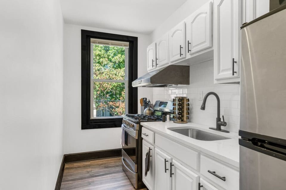 Modern stainless-steel appliances and stylish design define the kitchen
