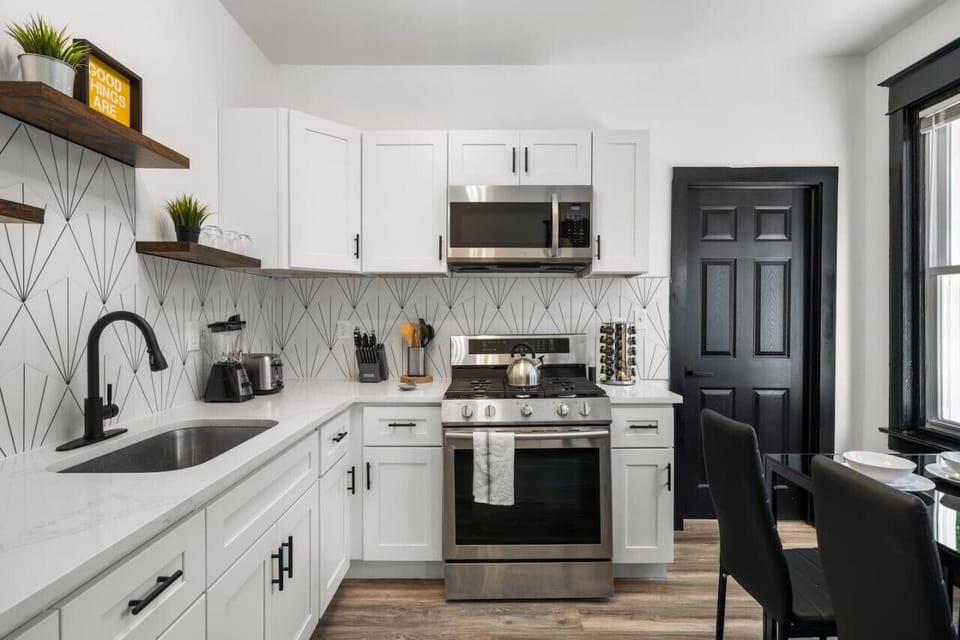 Modern stainless-steel appliances and stylish design define the kitchen