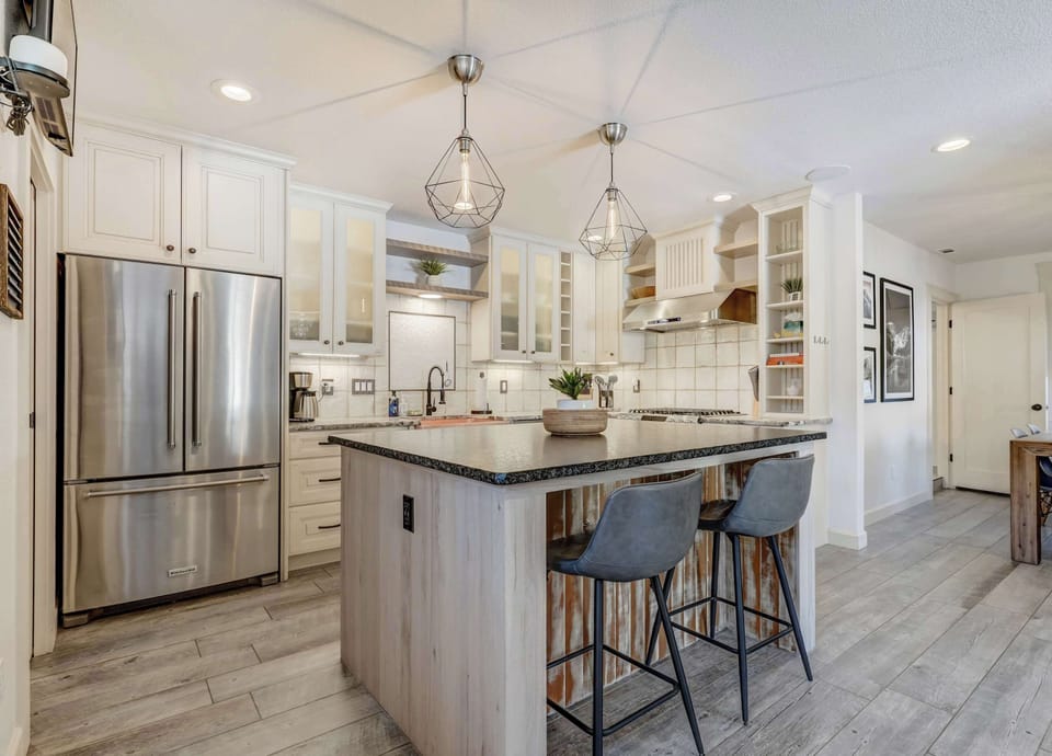 This beautifully designed kitchen features modern appliances, a spacious island, and elegant lighting—perfect for cooking, dining, and gathering.