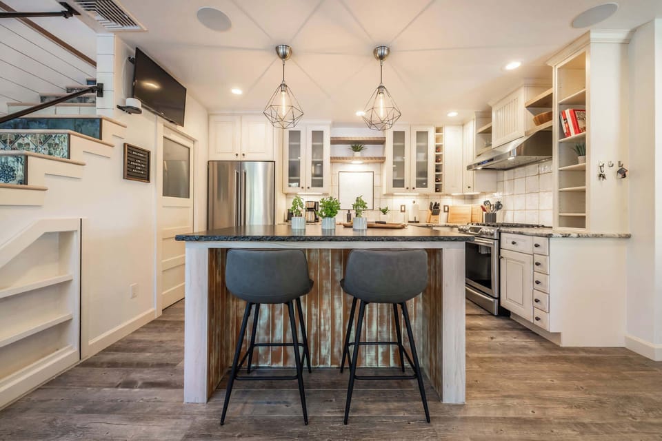 This fully remodeled kitchen wants for nothing: great lighting, fully equipped, storage galore, in-ceiling speakers, gas stove, vent hood, walk-in pantry, island seating and an easy place to gather. Don't miss the details like the custom stair tiles