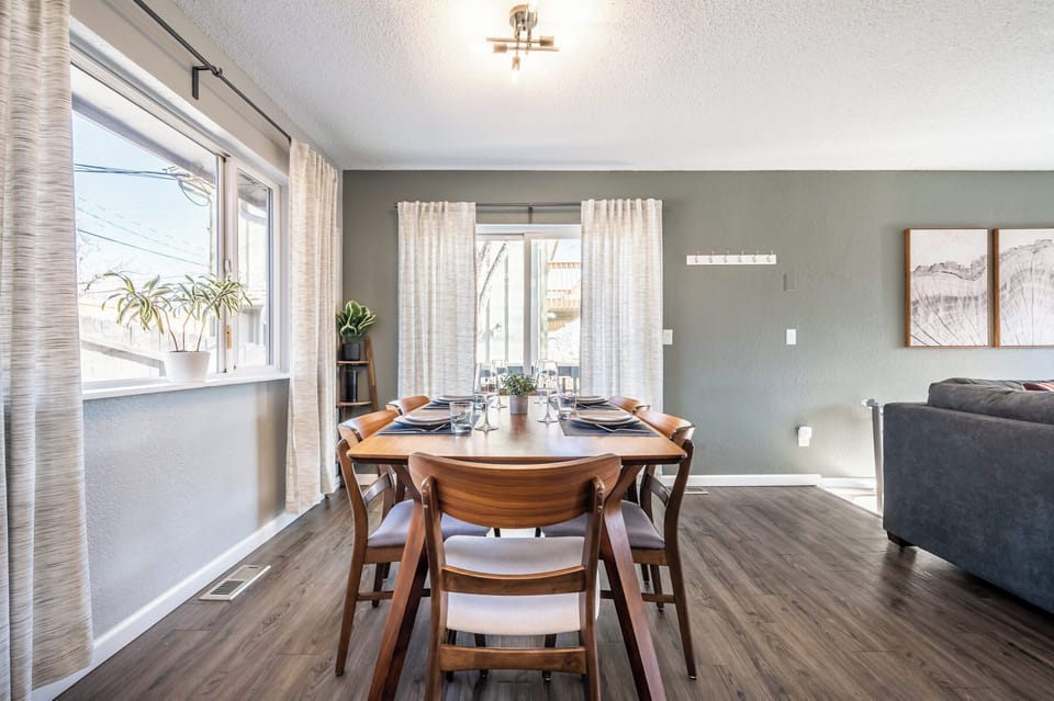 Open-concept dining area with seating for six, steps from the fully stocked kitchen and cozy living room.

