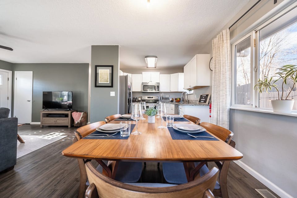 Open-concept dining area with seating for six, steps from the fully stocked kitchen and cozy living room.

