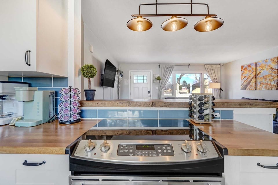 Get cooking in style with this kitchen scene, where the stove takes center stage flanked by convenient K-cups and fresh herbs for culinary inspiration.