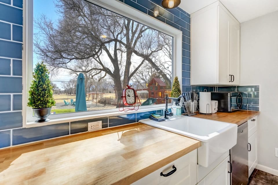 Let the sunlight stream in as you tackle chores at the sink, enjoying the tranquil view of the backyard through the expansive window.