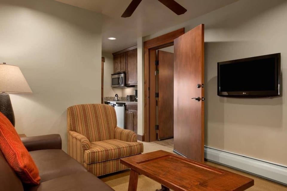 Guest bedroom also features a small living area that converts to a queen size sleeper sofa.