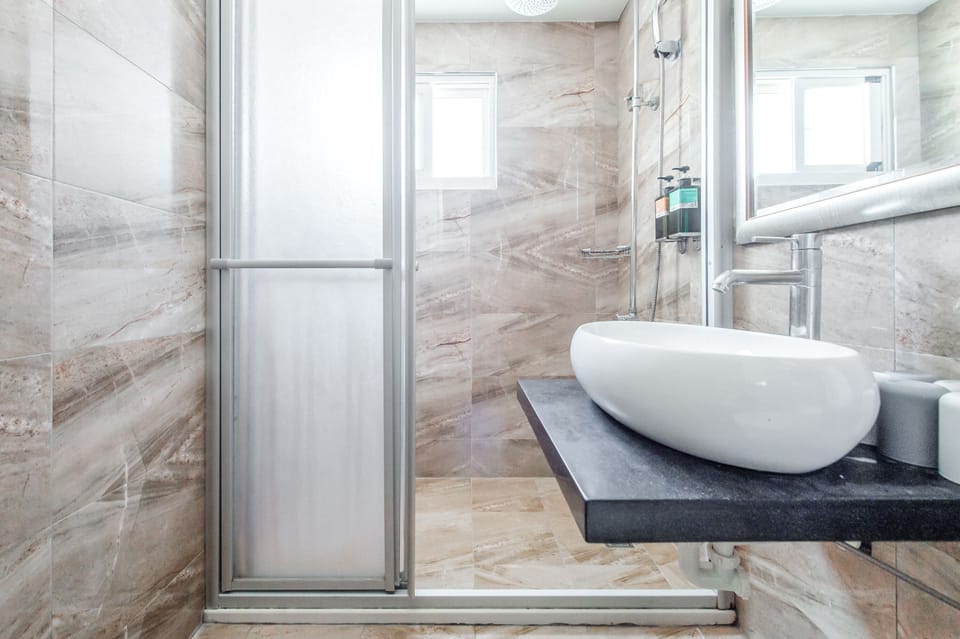 Family Room | Bathroom | Shower, hair dryer, slippers, towels