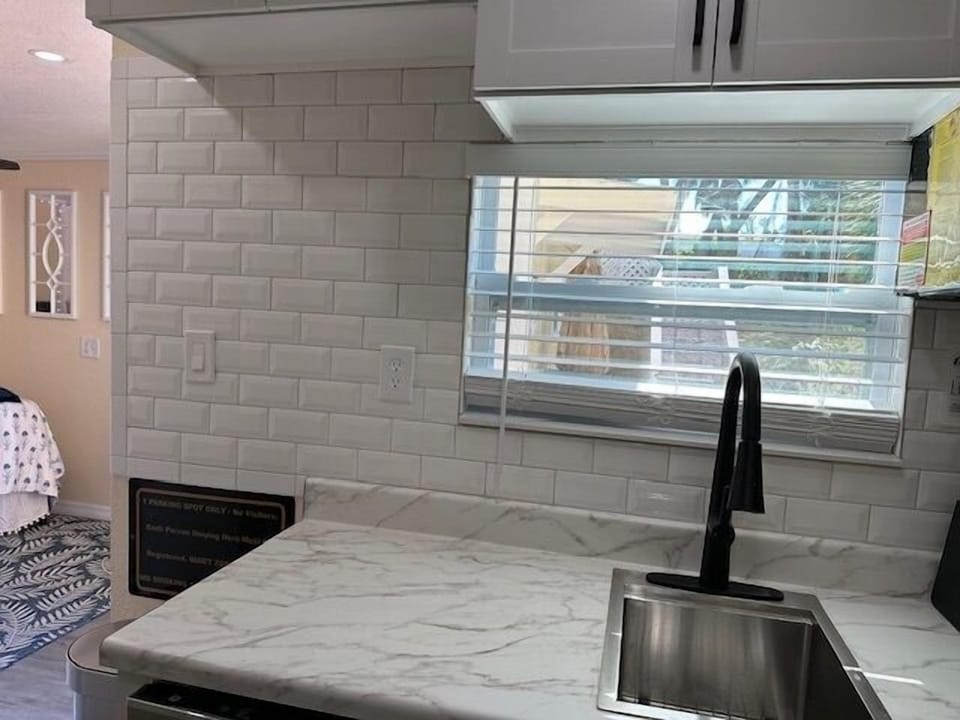 a tiny peakaboo window over the sink has a view or our tropical planting area with palm tree on the side front corner of Blue Island Inn.  Teeny Bikini doesn't have a water view from the unit but guests can just walk around back outside for extraordinary views of stunning Lemon Bay 