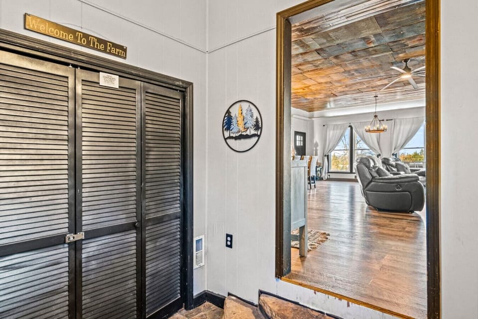 The entrance to the farmhouse. Hooks are located in the entryway for coats/jackets and there is also a bench.