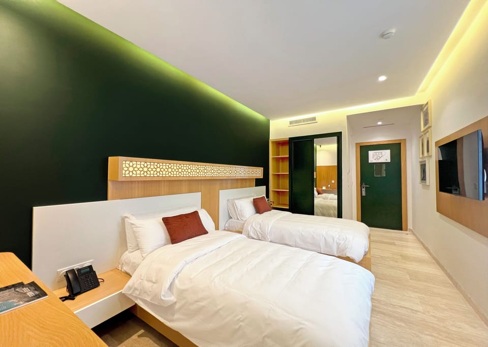 Economy Double Room | Minibar, in-room safe, desk, blackout drapes