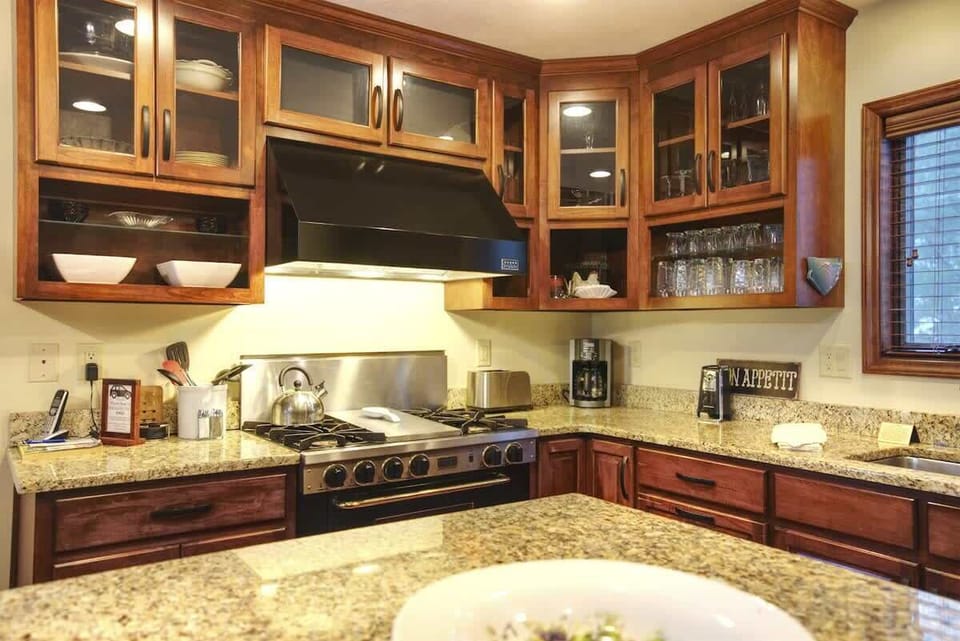 Closed and open cabinetry and granite countertops.