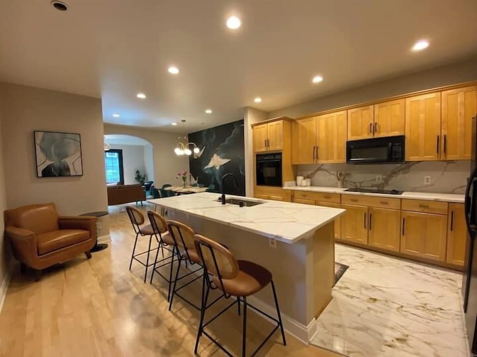 Spacious and modern open-concept kitchen with a large marble island