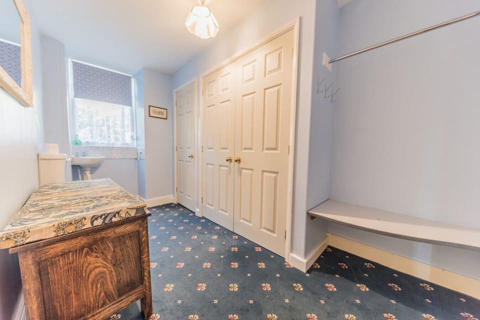 Toilet room and storage cupboard for high chair and travel cot