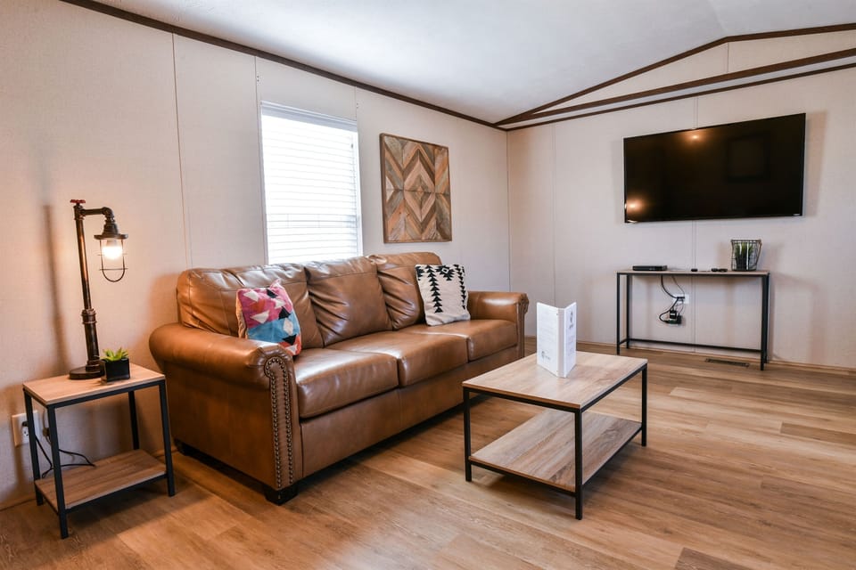 Comfortable leather couch and TV for relaxing.