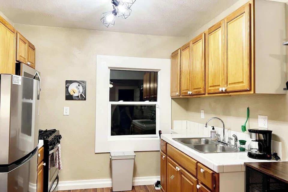 A handy kitchen setup with cabinets and essentials to make you feel right at home. 🥘