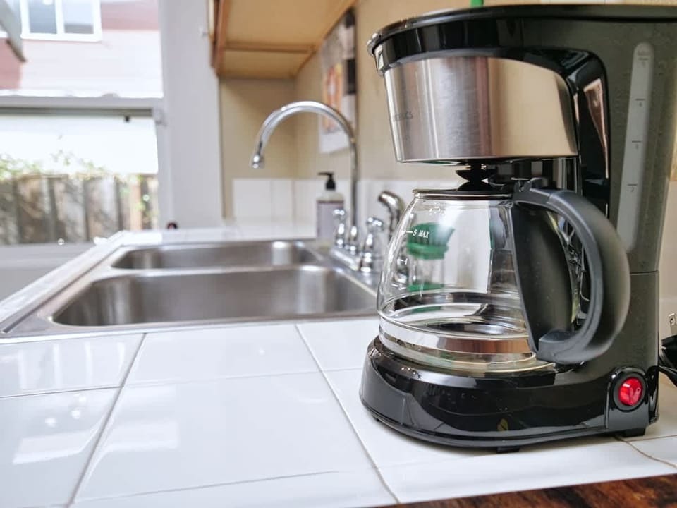 Your mornings are made simple with a coffee maker ready to brew your first cup of the day. ☕