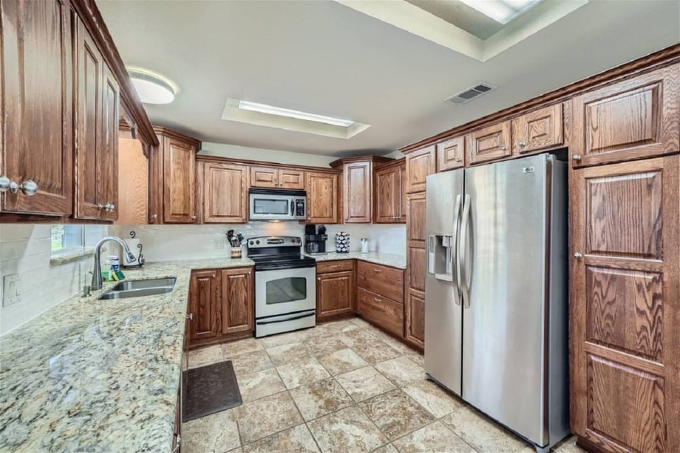 Fully stocked kitchen with granite and stainless steel appliances