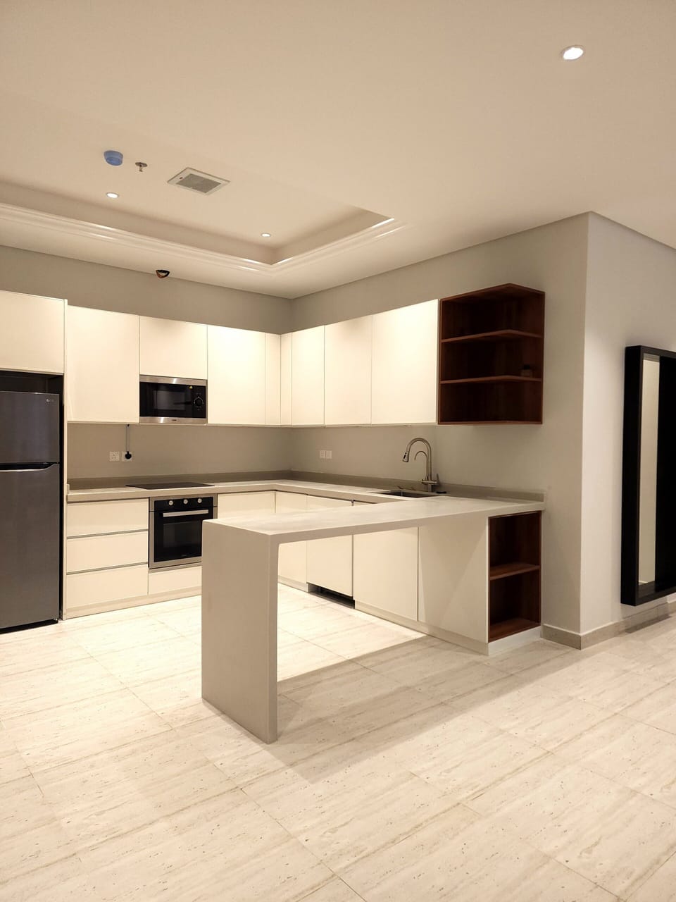 Fully equipped kitchen with stove top, oven, fridge, microwave, and dishwasher