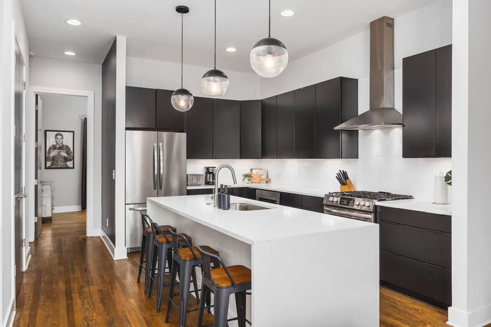 Fully-stocked chef's kitchen with a gas range, wet bar, seating for four at the island, and all the appliances / tools you could need to cook and enjoy a meal together.
