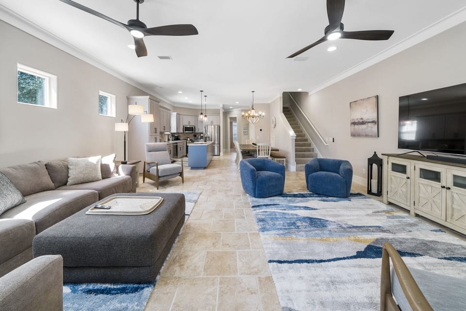 Relax in your spacious open-concept living area with plush seating, modern kitchen, and coastal-inspired décor creating the perfect gathering space.