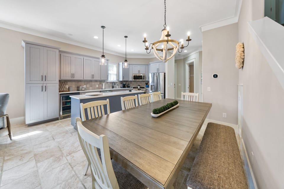 You'll love gathering around this spacious dining table, perfectly positioned between your fully equipped kitchen and cozy living area for memorable meals together.