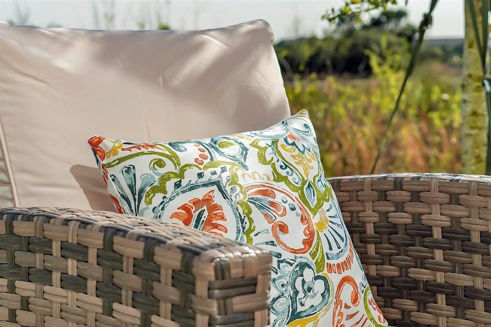 Outdoor lounge w/ patterned throw pillows made for lazy afternoon relaxing.
