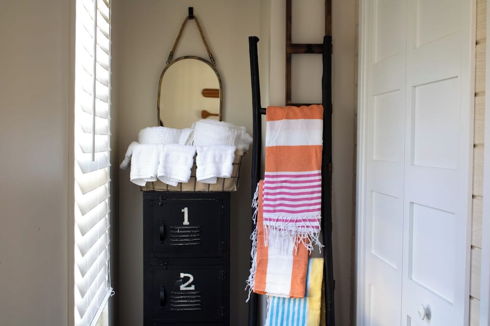 Colorful beach towels and white bath linens available for your stay