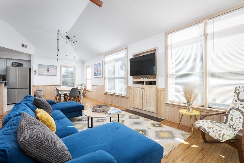 Modern open-concept living room, kitchen & dining with plenty of natural light