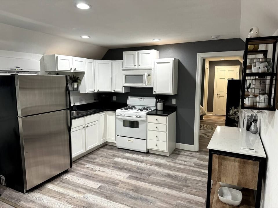 Full kitchen with gas range, microwave, full refrigerator, and K cup coffee maker.