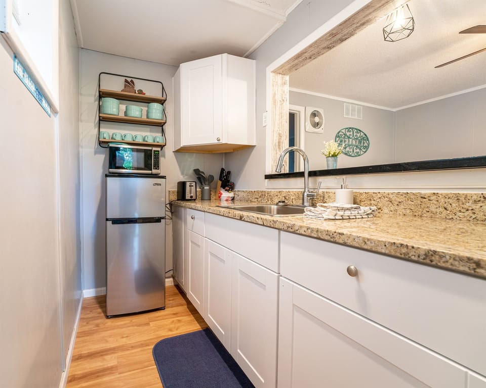 Newly renovated kitchenette - small fridge/freezer, hot plate, microwave. No dishwasher or oven range.
