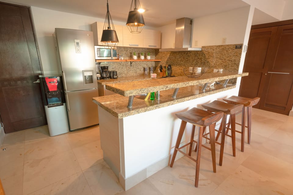 Deluxe Condo | Private kitchen | Full-size fridge, microwave, toaster, blender