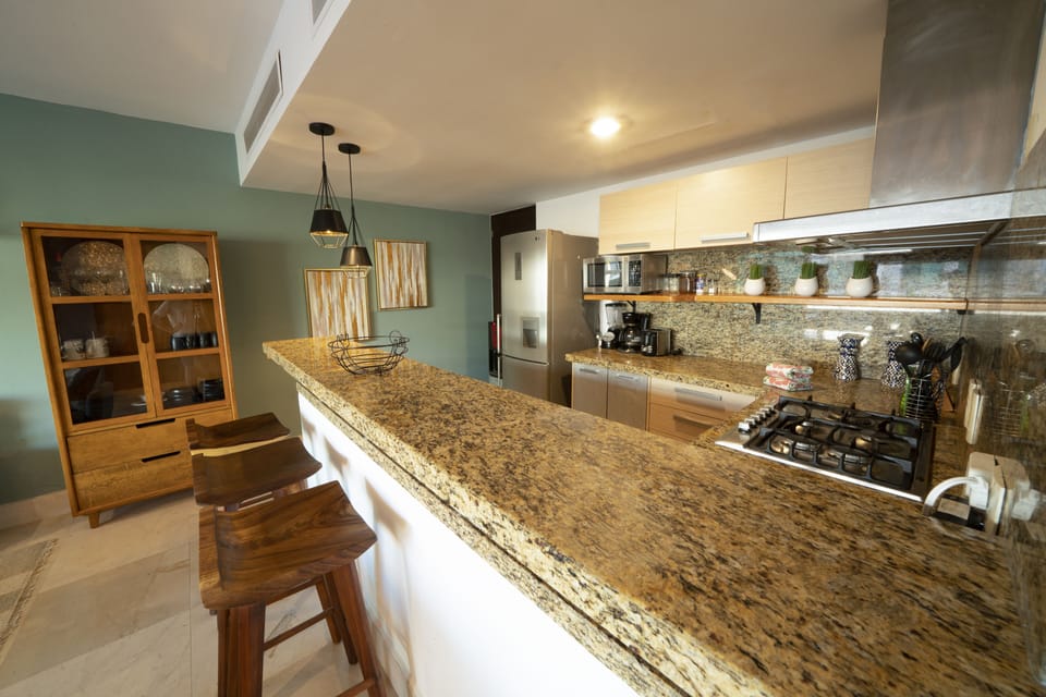 Deluxe Condo | Private kitchen | Full-size fridge, microwave, toaster, blender
