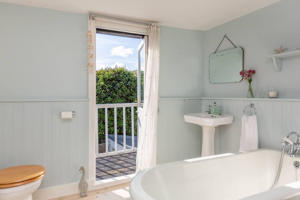 1st Floor Bathroom with handheld shower head, WC and basin