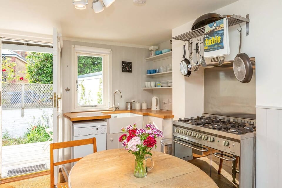 Open plan living room, dining room and kitchen with log burner.