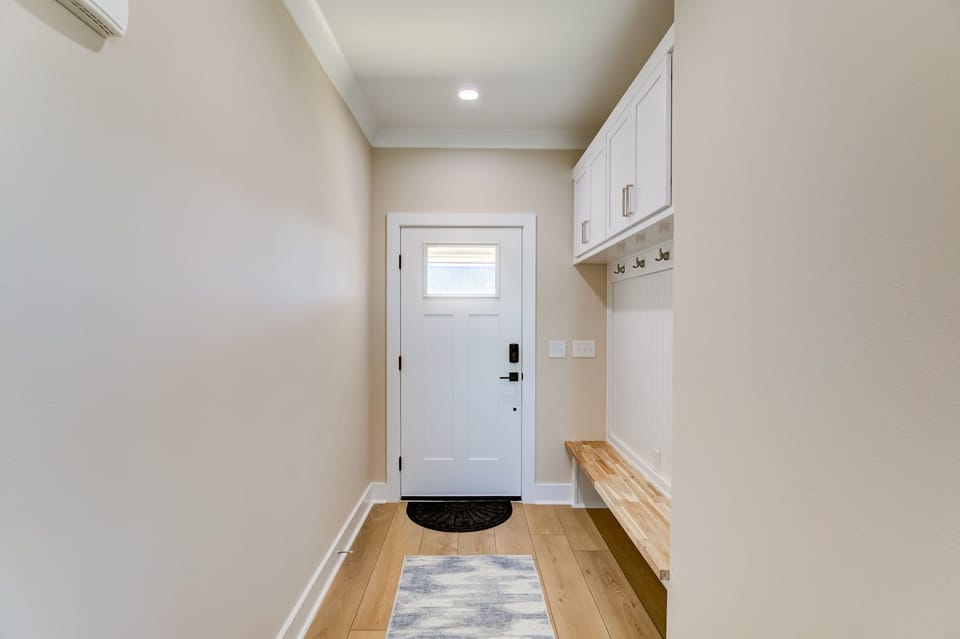Entryway with bench, hooks for bags , and cabinets