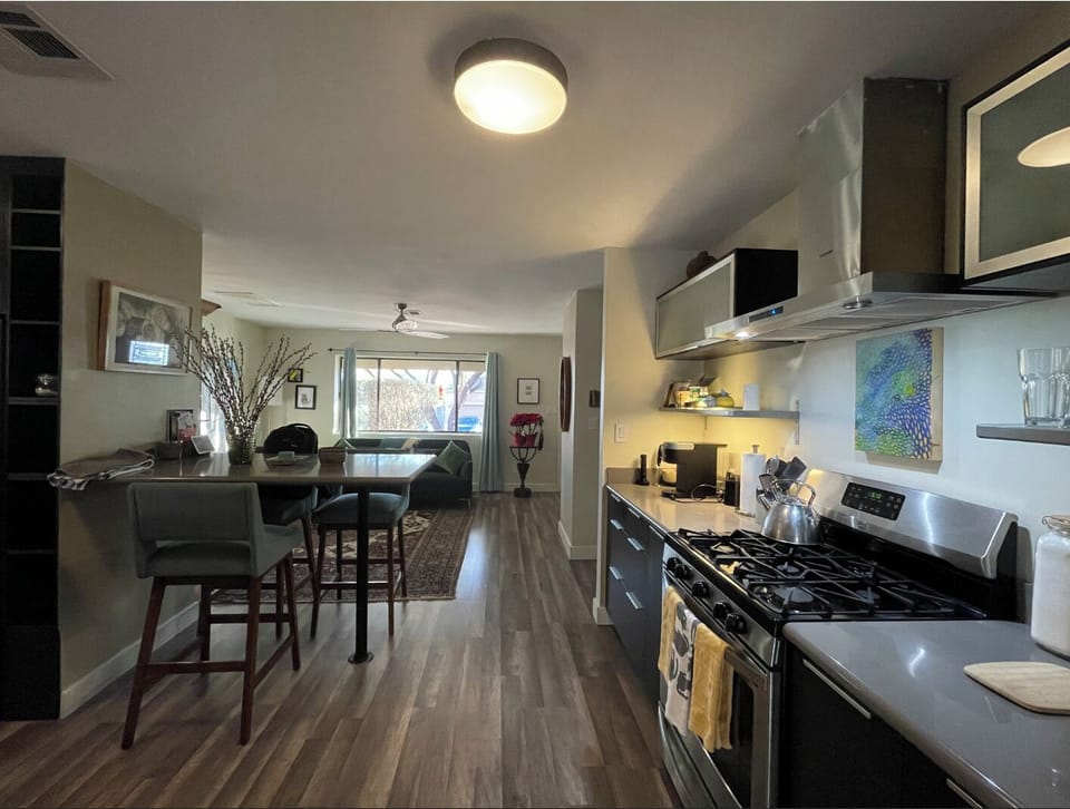 Kitchen facing living room and front of home window. 