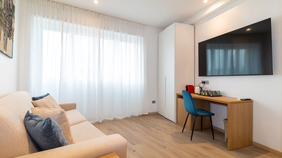 Deluxe Quadruple Room | Down comforters, memory foam beds, in-room safe, individually furnished