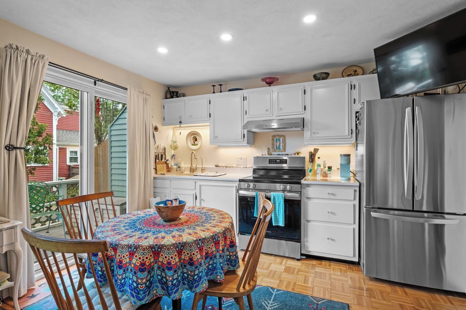 Dining/kitchen area-well applianced. Patio doors.  Smart TV.