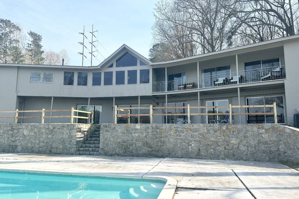 Back of the house that faces the lake, 6 bedrooms to the right all have views of the lake and the pool!